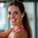 Happy client Jessica L. smiling at the gym.